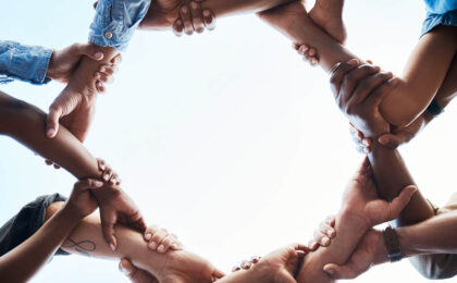 image of people joing arms