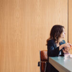 Two Women in a meeting in a wooden panelled office.